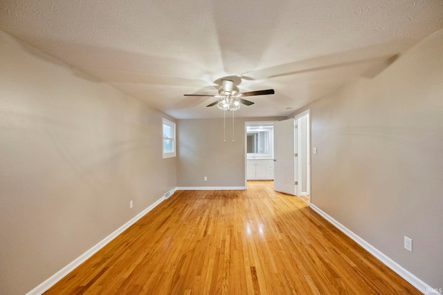 2213 Old Oak Dr, West Lafayette, IN 47906 - empty room featuring baseboards, a ceiling fan, light wood finished floors, and a textured ceiling