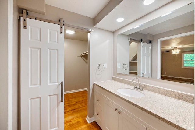 2213 Old Oak Dr, West Lafayette, IN 47906 - bathroom with vanity, wood finished floors, ceiling fan, and baseboards