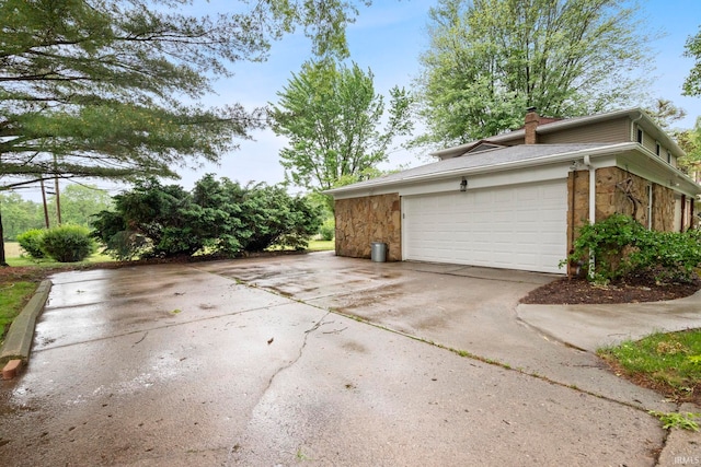 2213 Old Oak Dr, West Lafayette, IN 47906 - view of property exterior featuring a chimney and an attached garage