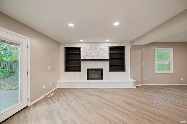 2213 Old Oak Dr, West Lafayette, IN 47906 - unfurnished living room featuring baseboards, built in shelves, light wood-style floors, a fireplace, and recessed lighting