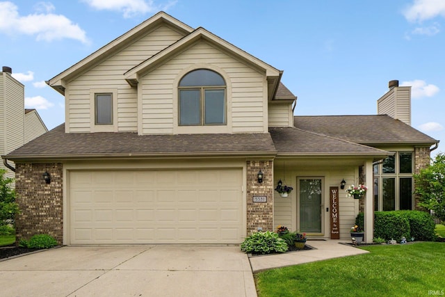 5531 Gate Tree Ln, Fort Wayne, IN 46835 - view of front of home featuring brick siding, concrete driveway, an attached garage, a front lawn, and a shingled roof