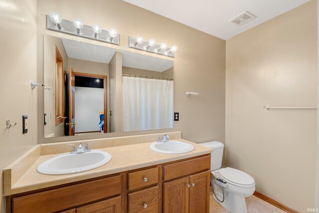 5531 Gate Tree Ln, Fort Wayne, IN 46835 - bathroom featuring double vanity, toilet, and tile patterned flooring