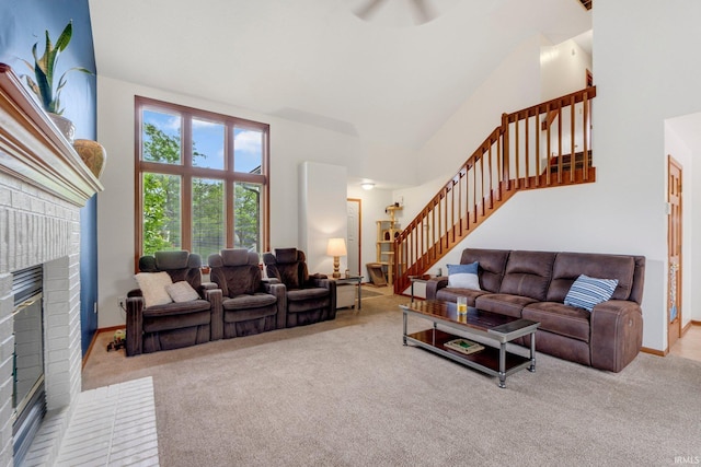5531 Gate Tree Ln, Fort Wayne, IN 46835 - carpeted living area with a fireplace, stairs, ceiling fan, high vaulted ceiling, and baseboards