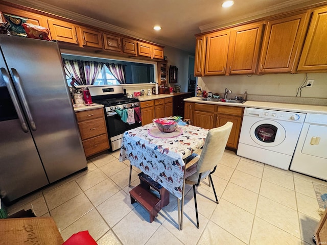 1005 Elm St, Plymouth, IN 46563 - kitchen with stainless steel appliances, separate washer and dryer, a sink, light tile patterned floors, and recessed lighting