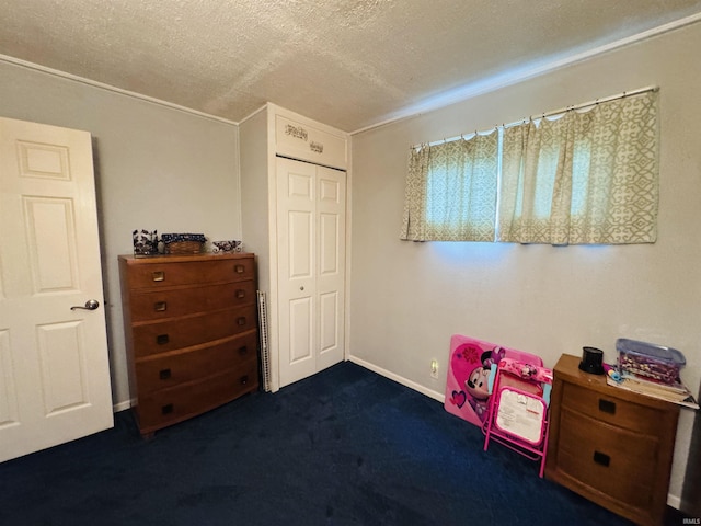 1005 Elm St, Plymouth, IN 46563 - bedroom featuring a textured ceiling, dark colored carpet, a closet, and baseboards