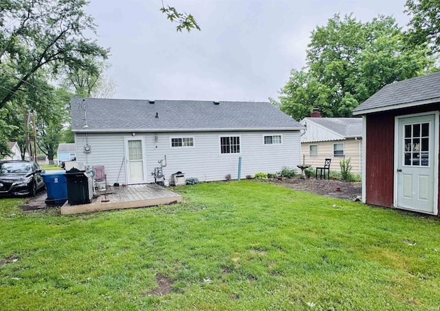 1005 Elm St, Plymouth, IN 46563 - back of property featuring a deck, a lawn, an outbuilding, and a shingled roof