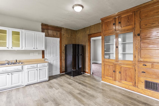 2121 Parnell Ave, Fort Wayne, IN 46805 - kitchen with freestanding refrigerator, a sink, light countertops, white cabinetry, and glass insert cabinets