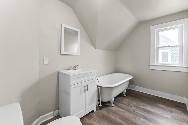 2121 Parnell Ave, Fort Wayne, IN 46805 - full bathroom featuring a freestanding bath, vaulted ceiling, toilet, vanity, and wood finished floors