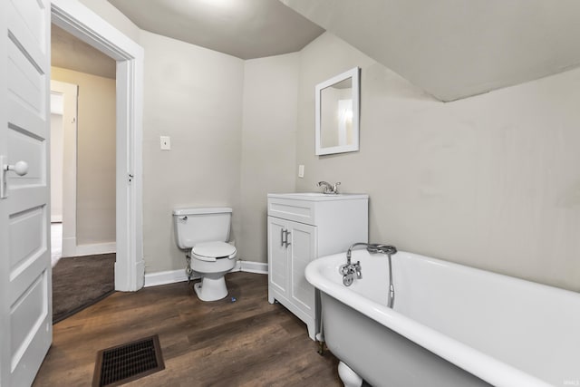 2121 Parnell Ave, Fort Wayne, IN 46805 - full bathroom featuring a soaking tub, wood finished floors, vanity, toilet, and baseboards