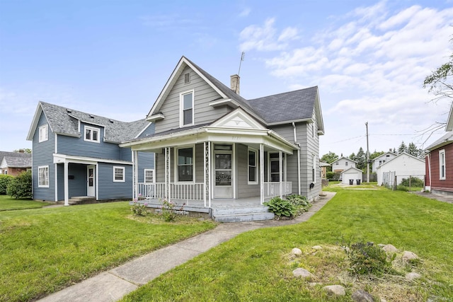 2121 Parnell Ave, Fort Wayne, IN 46805 - view of front facade featuring covered porch, a front lawn, a chimney, and a shingled roof