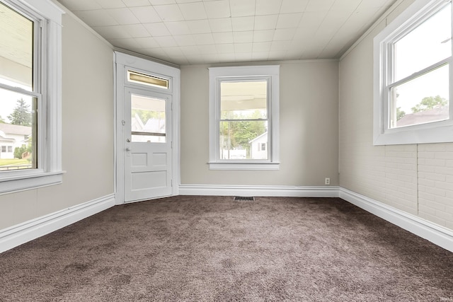 2121 Parnell Ave, Fort Wayne, IN 46805 - spare room featuring dark colored carpet, ornamental molding, and baseboards