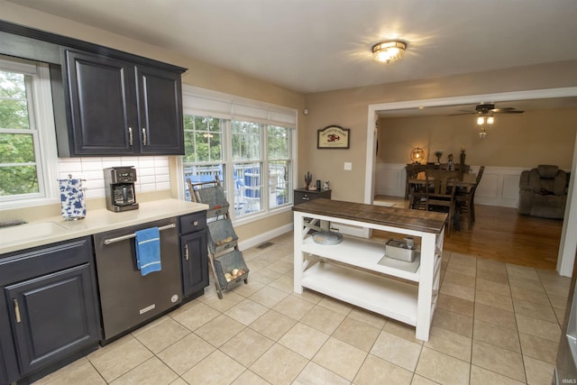 917 E Mill Creek Rd, Greensburg, IN 47240 - kitchen featuring light countertops, ceiling fan, light tile patterned floors, wainscoting, and backsplash