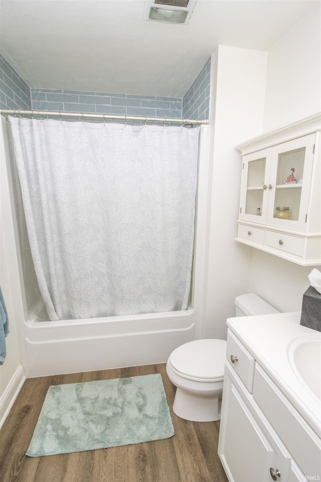 917 E Mill Creek Rd, Greensburg, IN 47240 - bathroom with toilet, vanity, wood finished floors, and shower / bathtub combination with curtain