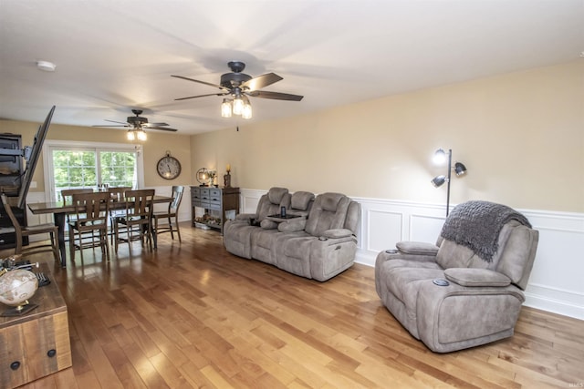917 E Mill Creek Rd, Greensburg, IN 47240 - living room with light wood-style floors, wainscoting, and a ceiling fan