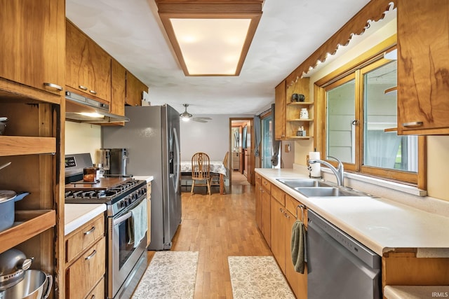 907 N Orchard Dr, North Manchester, IN 46962 - kitchen with appliances with stainless steel finishes, a sink, under cabinet range hood, brown cabinetry, and light countertops