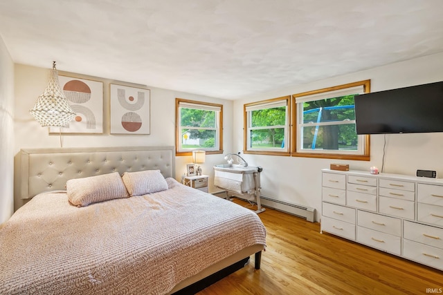 907 N Orchard Dr, North Manchester, IN 46962 - bedroom with light wood finished floors and baseboard heating
