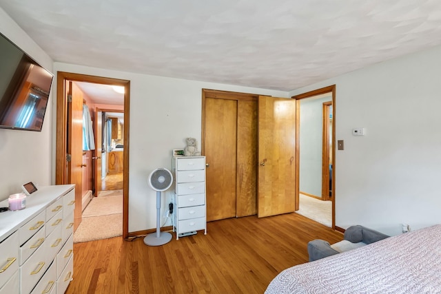 907 N Orchard Dr, North Manchester, IN 46962 - bedroom with light wood-style floors, a closet, and baseboards