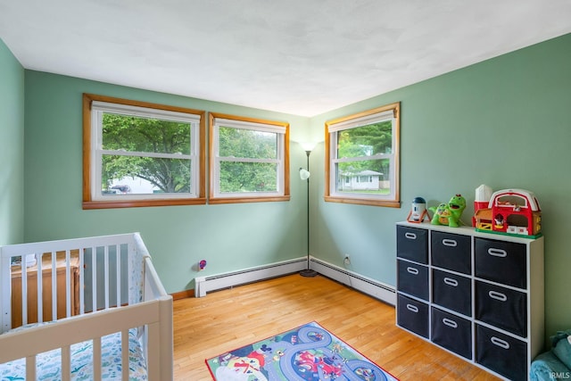 907 N Orchard Dr, North Manchester, IN 46962 - bedroom with wood finished floors and a baseboard radiator
