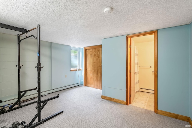 907 N Orchard Dr, North Manchester, IN 46962 - exercise room with baseboard heating, carpet floors, and baseboards