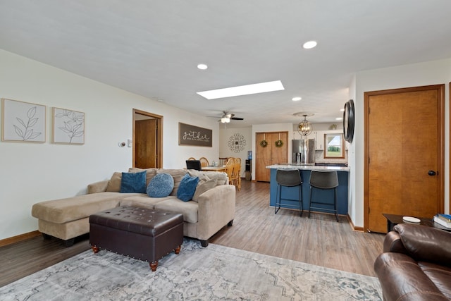 3705 E Forest Glen Ave, Leesburg, IN 46538 - living area featuring a skylight, light wood finished floors, recessed lighting, and baseboards