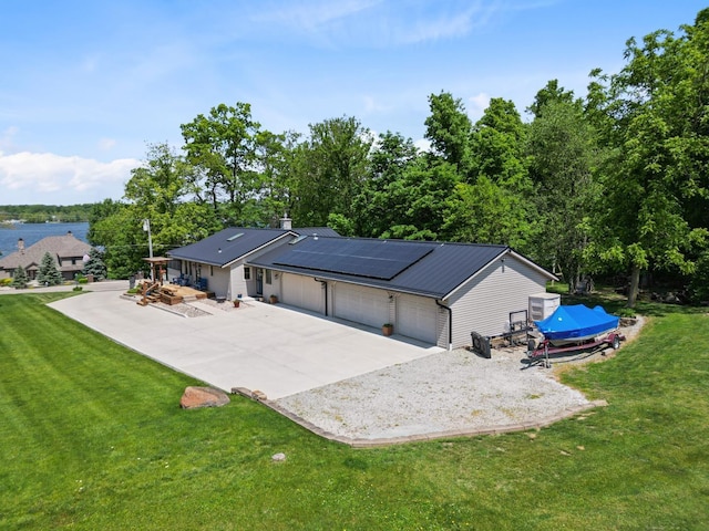 3705 E Forest Glen Ave, Leesburg, IN 46538 - view of front facade with driveway, solar panels, an attached garage, a front yard, and metal roof