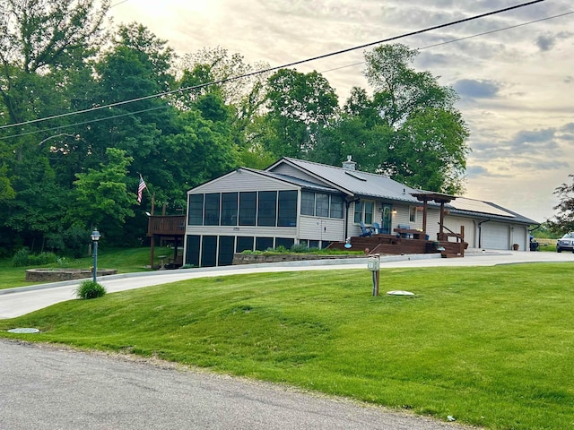 3705 E Forest Glen Ave, Leesburg, IN 46538 - view of front of home with a sunroom, a front yard, a garage, and metal roof