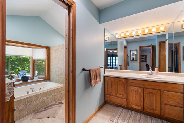 3705 E Forest Glen Ave, Leesburg, IN 46538 - bathroom featuring tile patterned flooring, a bath, vanity, baseboards, and lofted ceiling