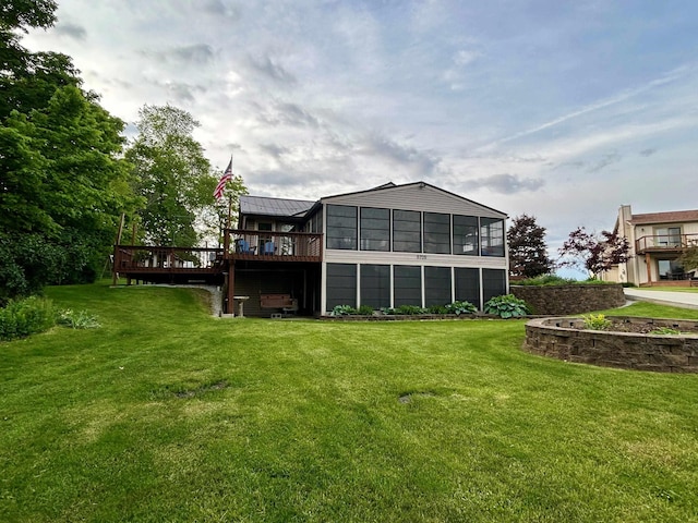 3705 E Forest Glen Ave, Leesburg, IN 46538 - rear view of property with a deck, a sunroom, a lawn, metal roof, and a standing seam roof