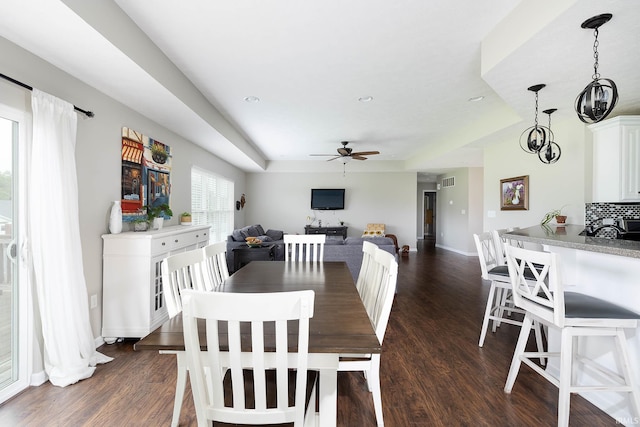 1154 S Deer Run, Ellettsville, IN 47429 - dining space with ceiling fan, dark wood-style floors, baseboards, a raised ceiling, and recessed lighting