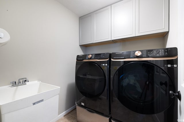 1154 S Deer Run, Ellettsville, IN 47429 - laundry room featuring washing machine and clothes dryer, cabinet space, light tile patterned floors, and baseboards