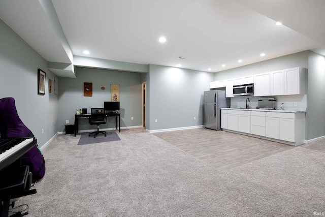 1154 S Deer Run, Ellettsville, IN 47429 - home office with light carpet, baseboards, recessed lighting, and a sink
