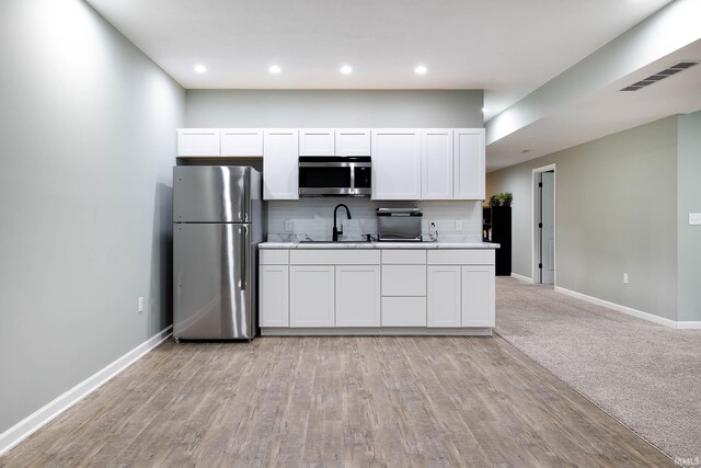 1154 S Deer Run, Ellettsville, IN 47429 - kitchen featuring appliances with stainless steel finishes, baseboards, backsplash, white cabinets, and recessed lighting