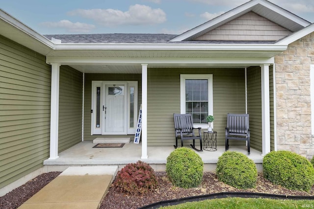 1154 S Deer Run, Ellettsville, IN 47429 - view of exterior entry with a porch, roof with shingles, and stone siding