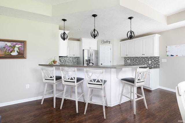 1154 S Deer Run, Ellettsville, IN 47429 - kitchen with stainless steel refrigerator with ice dispenser, a peninsula, dark wood finished floors, and baseboards