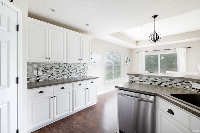 1154 S Deer Run, Ellettsville, IN 47429 - kitchen with stainless steel dishwasher, dark countertops, dark wood finished floors, decorative backsplash, and white cabinets