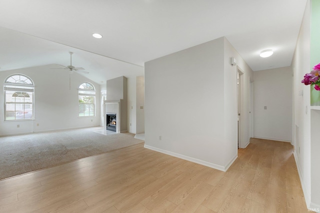 5248 Coventry Ln, Fort Wayne, IN 46804 - unfurnished living room with light wood-style floors, ceiling fan, baseboards, and lofted ceiling