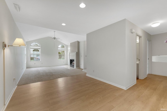 5248 Coventry Ln, Fort Wayne, IN 46804 - unfurnished living room featuring a ceiling fan, light wood-style flooring, baseboards, lofted ceiling, and recessed lighting