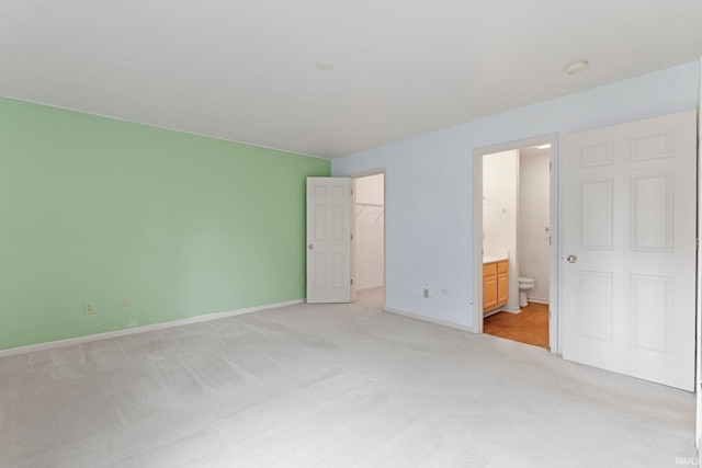 5248 Coventry Ln, Fort Wayne, IN 46804 - unfurnished bedroom with light carpet, a walk in closet, baseboards, ensuite bath, and a closet