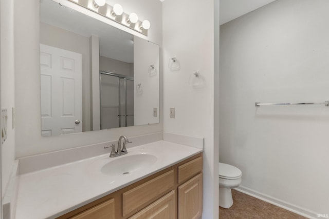 5248 Coventry Ln, Fort Wayne, IN 46804 - bathroom featuring toilet, vanity, a shower with shower door, and baseboards