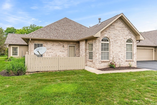 5248 Coventry Ln, Fort Wayne, IN 46804 - view of front facade featuring roof with shingles, an attached garage, asphalt driveway, and brick siding