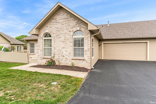 5248 Coventry Ln, Fort Wayne, IN 46804 - view of front of home featuring driveway, a shingled roof, an attached garage, and brick siding