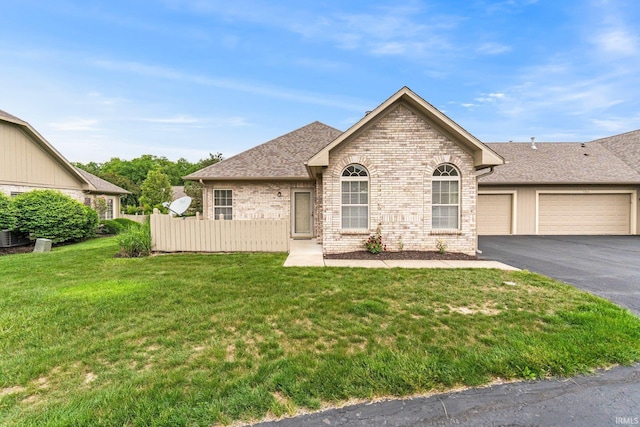 5248 Coventry Ln, Fort Wayne, IN 46804 - view of front of home with an attached garage, brick siding, asphalt driveway, and roof with shingles