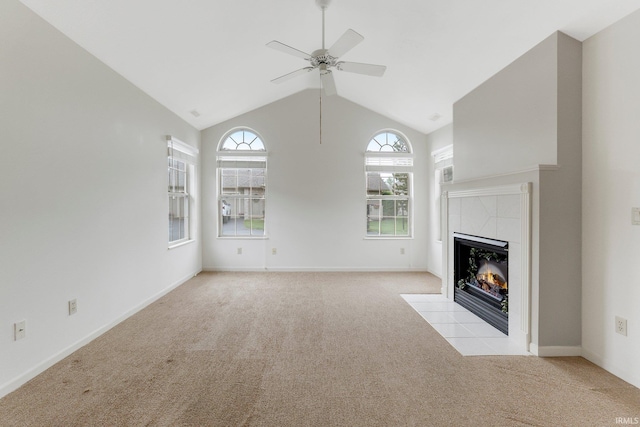 5248 Coventry Ln, Fort Wayne, IN 46804 - unfurnished living room with light carpet, ceiling fan, a tile fireplace, high vaulted ceiling, and baseboards