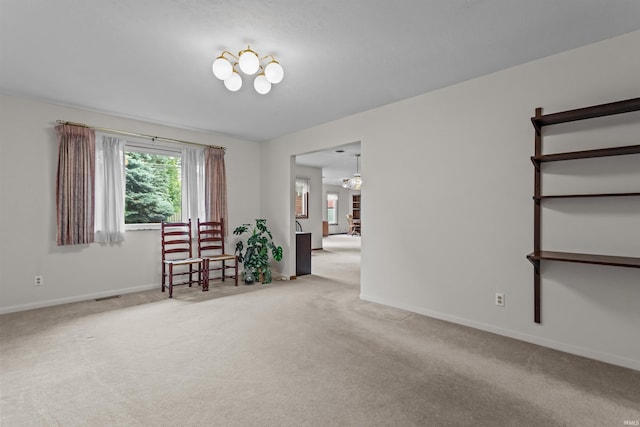 1105 E Southway Blvd, Kokomo, IN 46902 - spare room featuring a chandelier, carpet floors, and baseboards