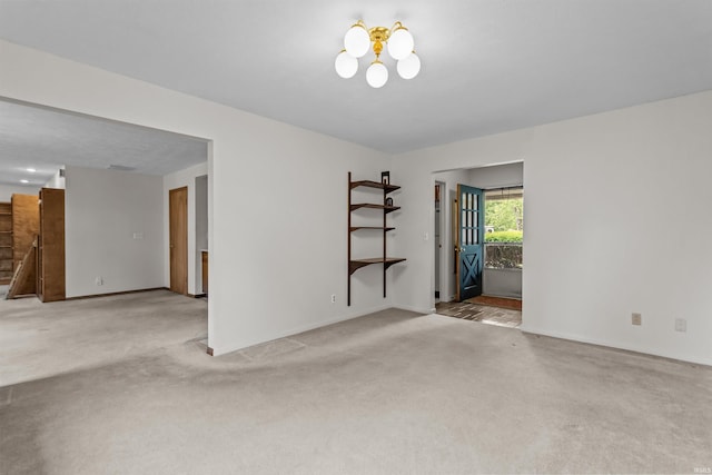 1105 E Southway Blvd, Kokomo, IN 46902 - unfurnished room featuring carpet flooring, a chandelier, and baseboards