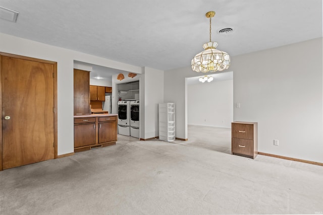 1105 E Southway Blvd, Kokomo, IN 46902 - kitchen featuring washer and clothes dryer, brown cabinetry, light colored carpet, baseboards, and light countertops