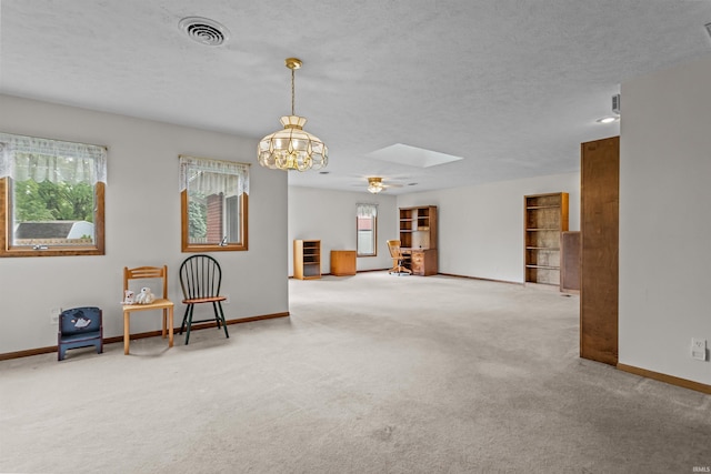 1105 E Southway Blvd, Kokomo, IN 46902 - empty room with baseboards, carpet, a skylight, a chandelier, and a textured ceiling
