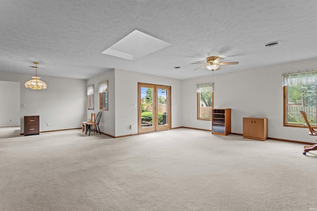 1105 E Southway Blvd, Kokomo, IN 46902 - carpeted spare room featuring baseboards, ceiling fan, a skylight, a textured ceiling, and a chandelier