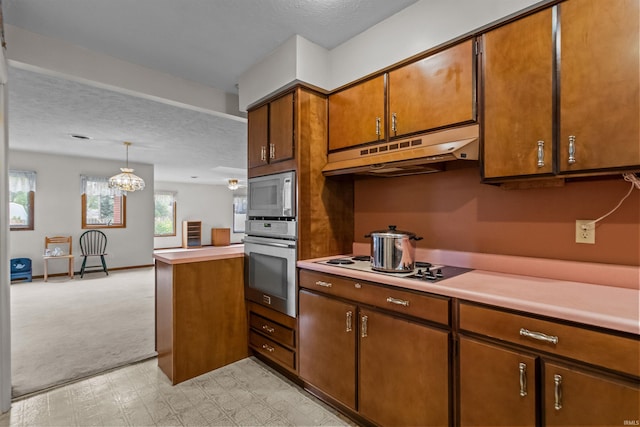 1105 E Southway Blvd, Kokomo, IN 46902 - kitchen with stainless steel oven, under cabinet range hood, black electric stovetop, light countertops, and a textured ceiling