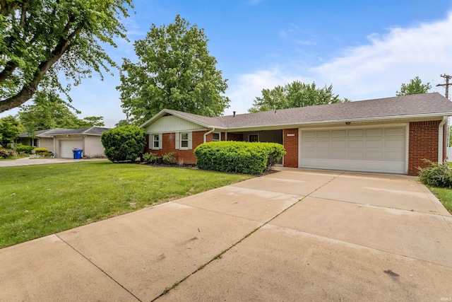1105 E Southway Blvd, Kokomo, IN 46902 - ranch-style house with brick siding, an attached garage, concrete driveway, and a front yard